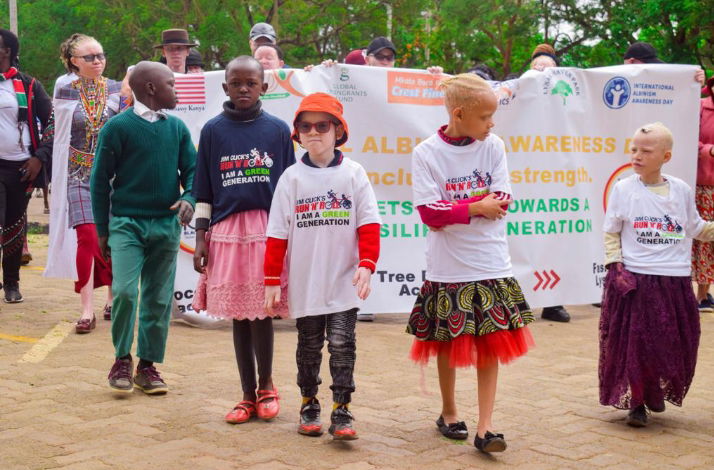 A picture with some kids with albinism during a procession walk for climate change advocacy.