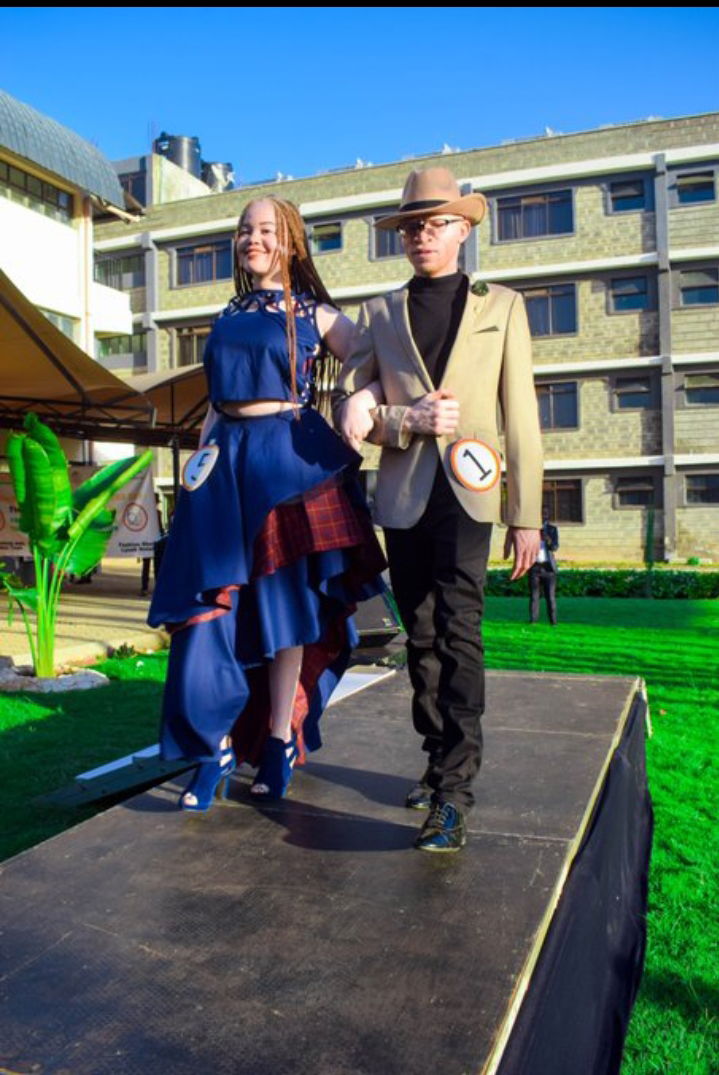 A picture of two persons with albinism during a catwalk to advicate for climate change action