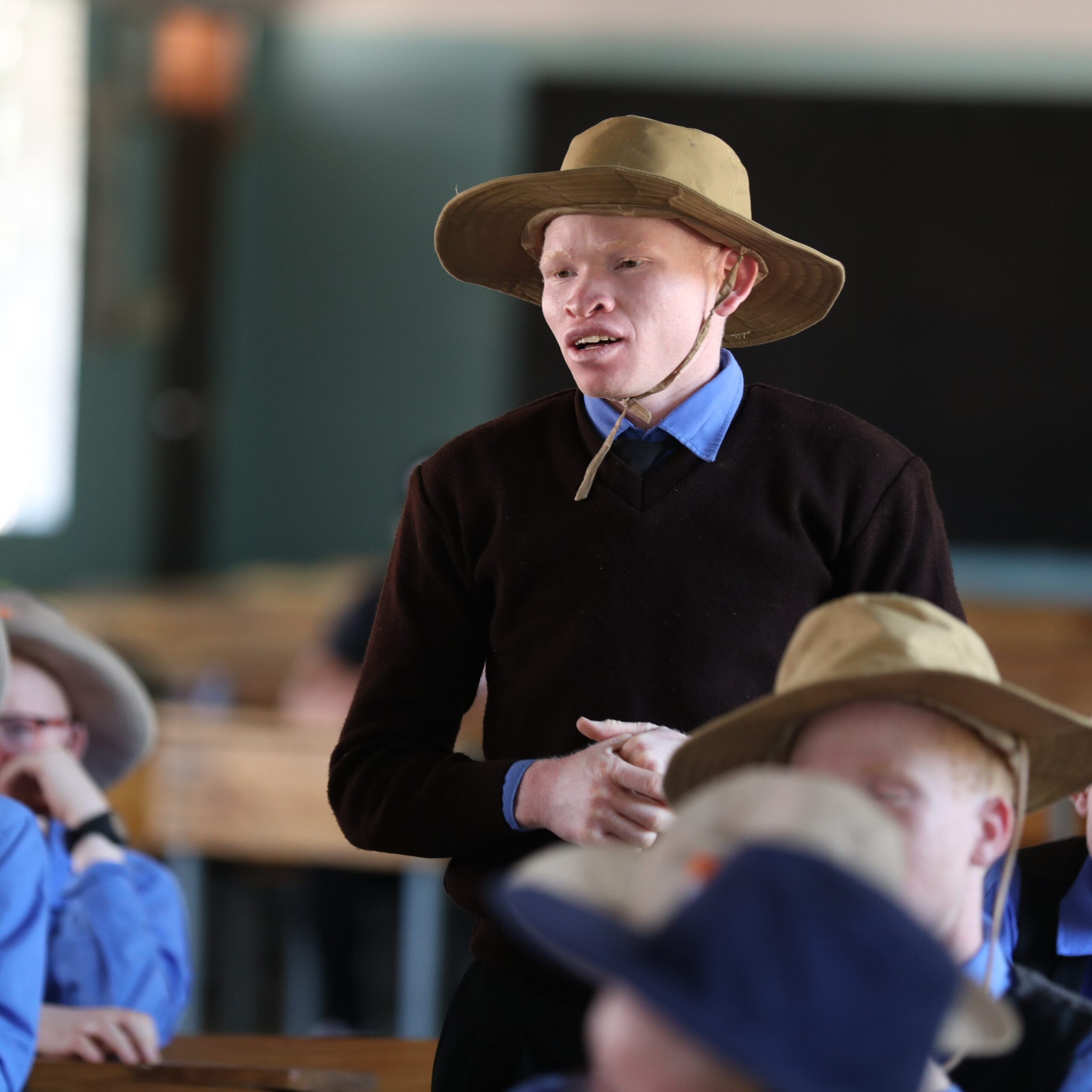 A male student standing in class