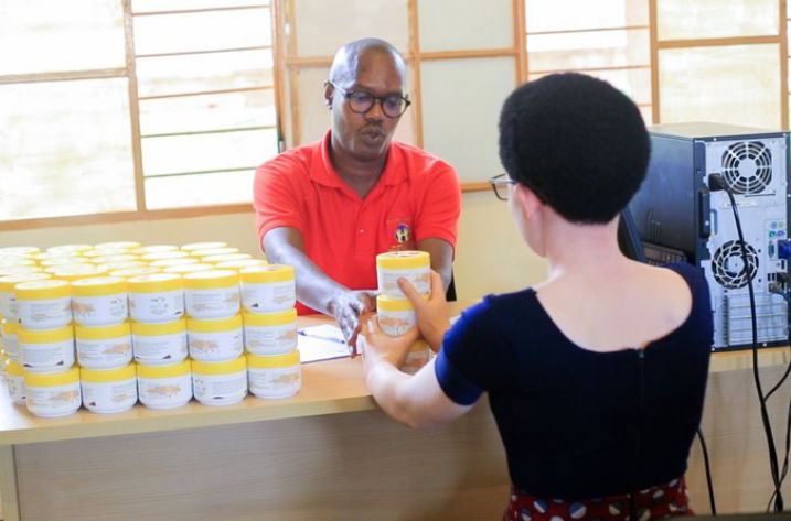 A healthcare practitioner handing over sunscreen