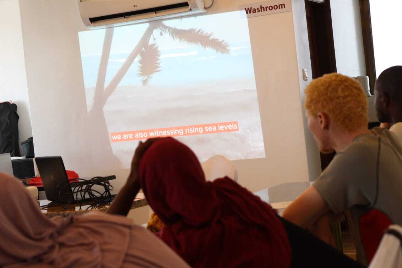 The participants of the training watching the video talking about climate change