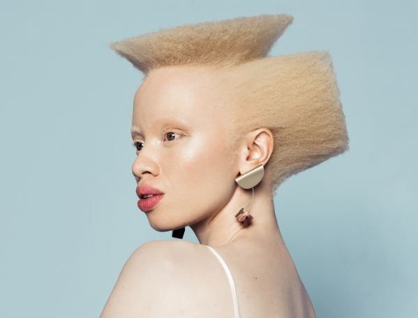 A picture of Thando Hopa as a model in her natural element-natural blond afro hair