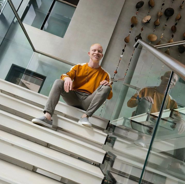 A picture of Jay sitting on a staircase