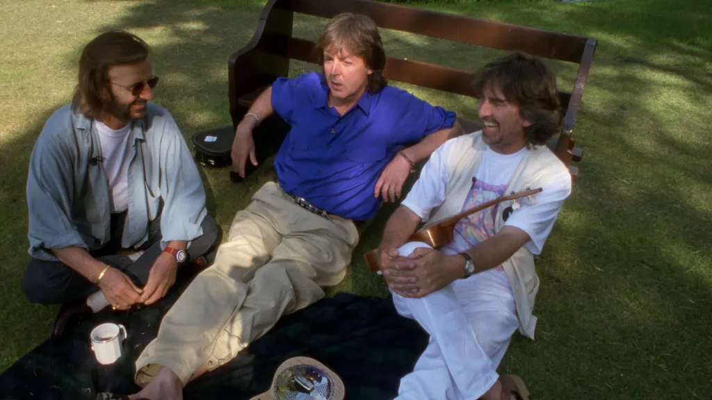  Surviving members of The Beatles—Ringo Starr, Paul McCartney, and George Harrison—sit and talk together in a garden during the filming of the Anthology documentary in 1994 and 1995. This intimate reunion at Harrison's Friar Park estate saw the trio, often referred to as the "Threetles," reminisce about their career and record new material like "Free as a Bird".  The relaxed outdoor setting captured in the Anthology series highlights a rare period of reconciliation for the band following decades of tension. While John Lennon's absence was deeply felt, he was represented through archival footage and his original demos, which the remaining members completed as part of the project. In 2025, a re-edited version titled Anthology 2025 was released on Disney+, featuring a new ninth episode with more of this previously unseen, casual footage of the three legends together.