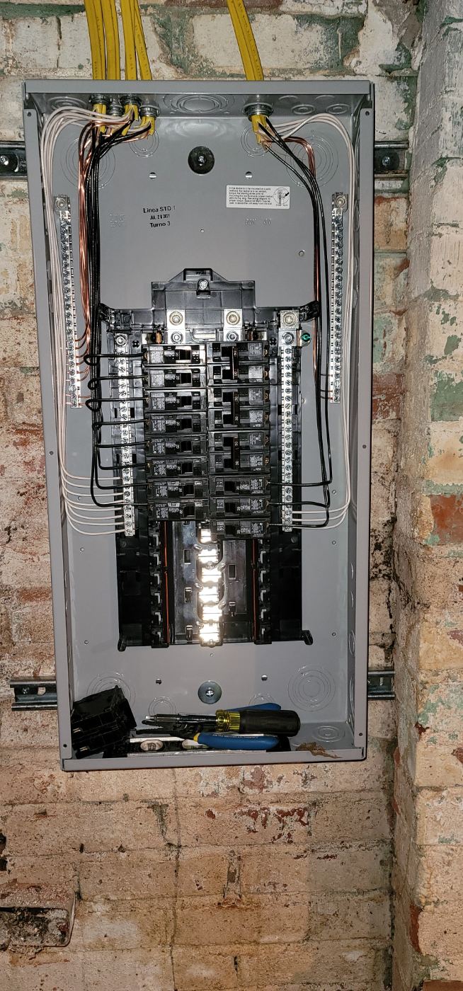 New breaker panel installed in a brick basement by Stickler’s Electrical Service in Lenoir, NC