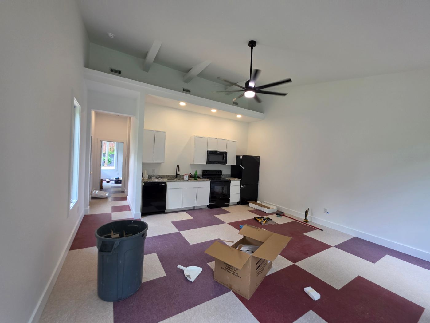 Kitchen and living area with recessed lights and a ceiling fan in a new duplex near Morganton, NC