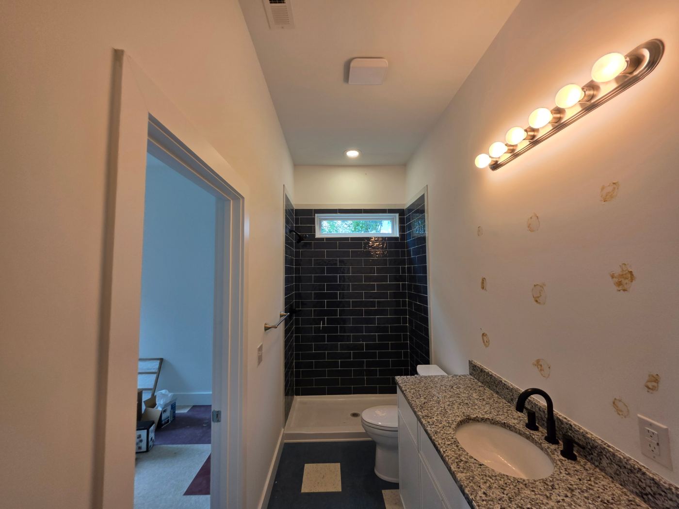 Bathroom with vanity light, recessed light and exhaust fan in a new duplex near Morganton, NC