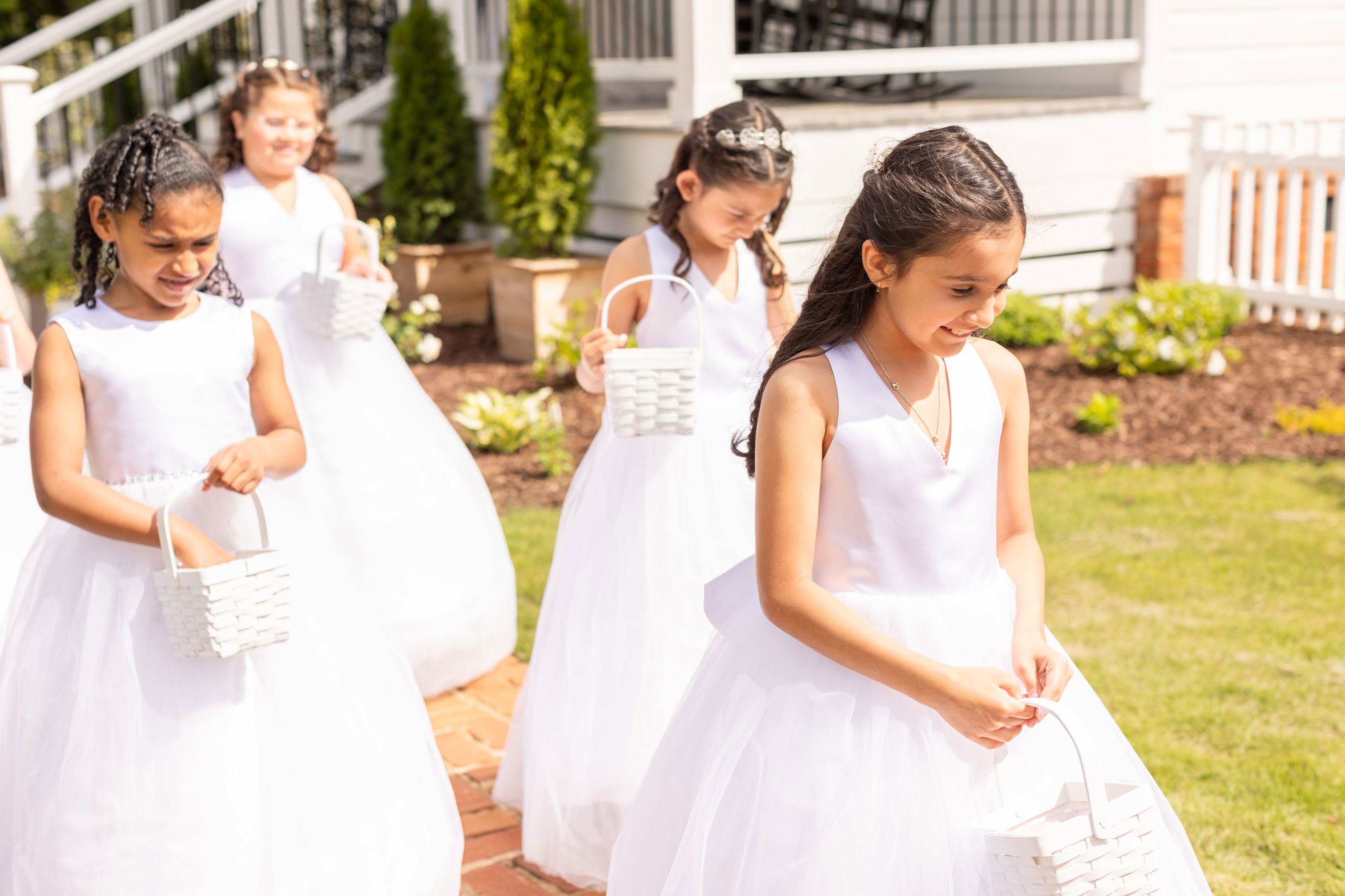flower girls at the cottage courtyard for April wedding ceremony in Monroe, GA in the spring