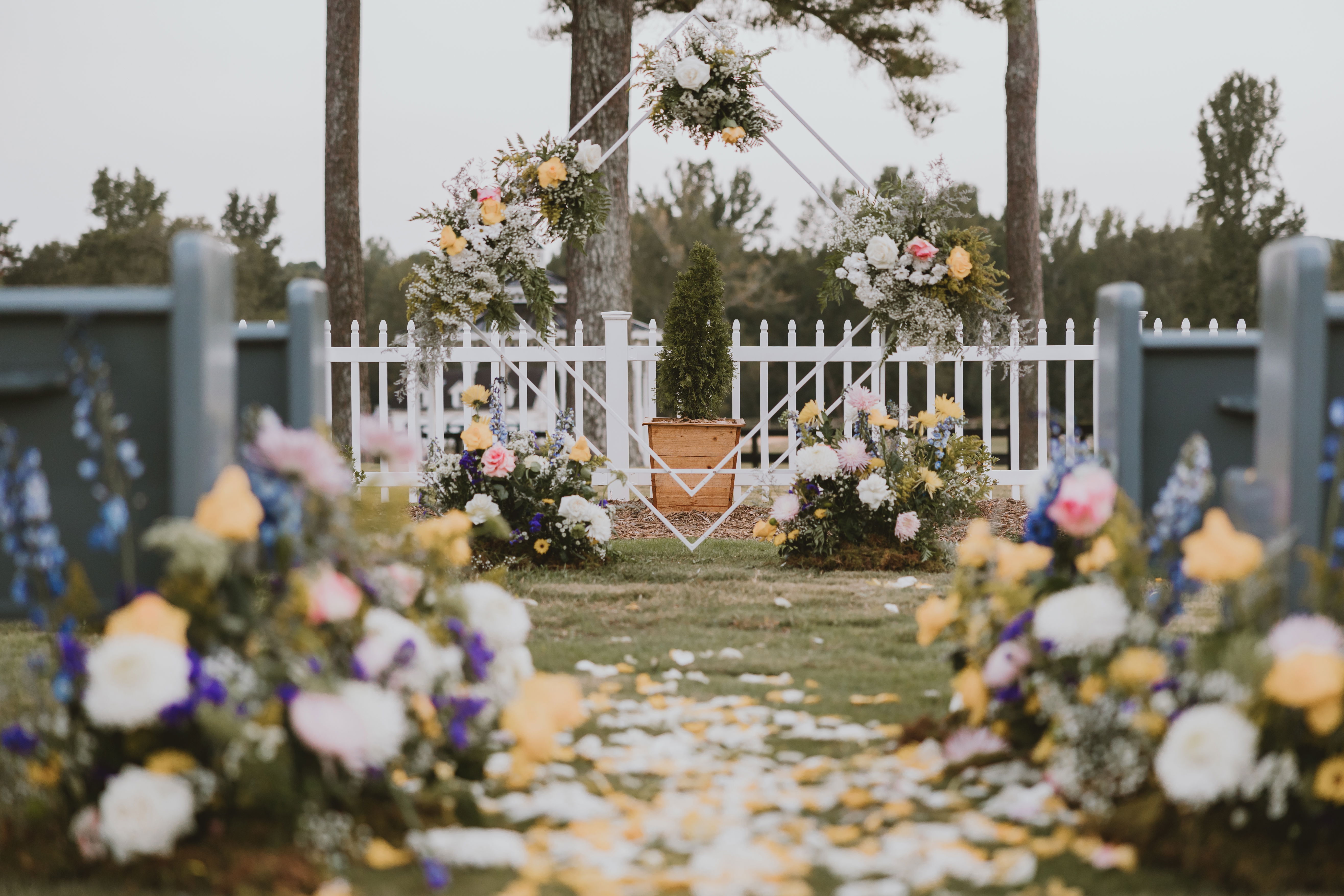 dreamy garden wedding ceremony with lush florals in courtyard with geometric arch in the countryside near Oconee County, Georgia