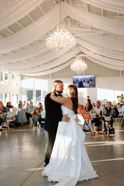 crystal chandeliers, chiffon draping, fairy lights in reception room with bride and groom first dance for fall wedding in Monroe, GA near Athens, Georgia