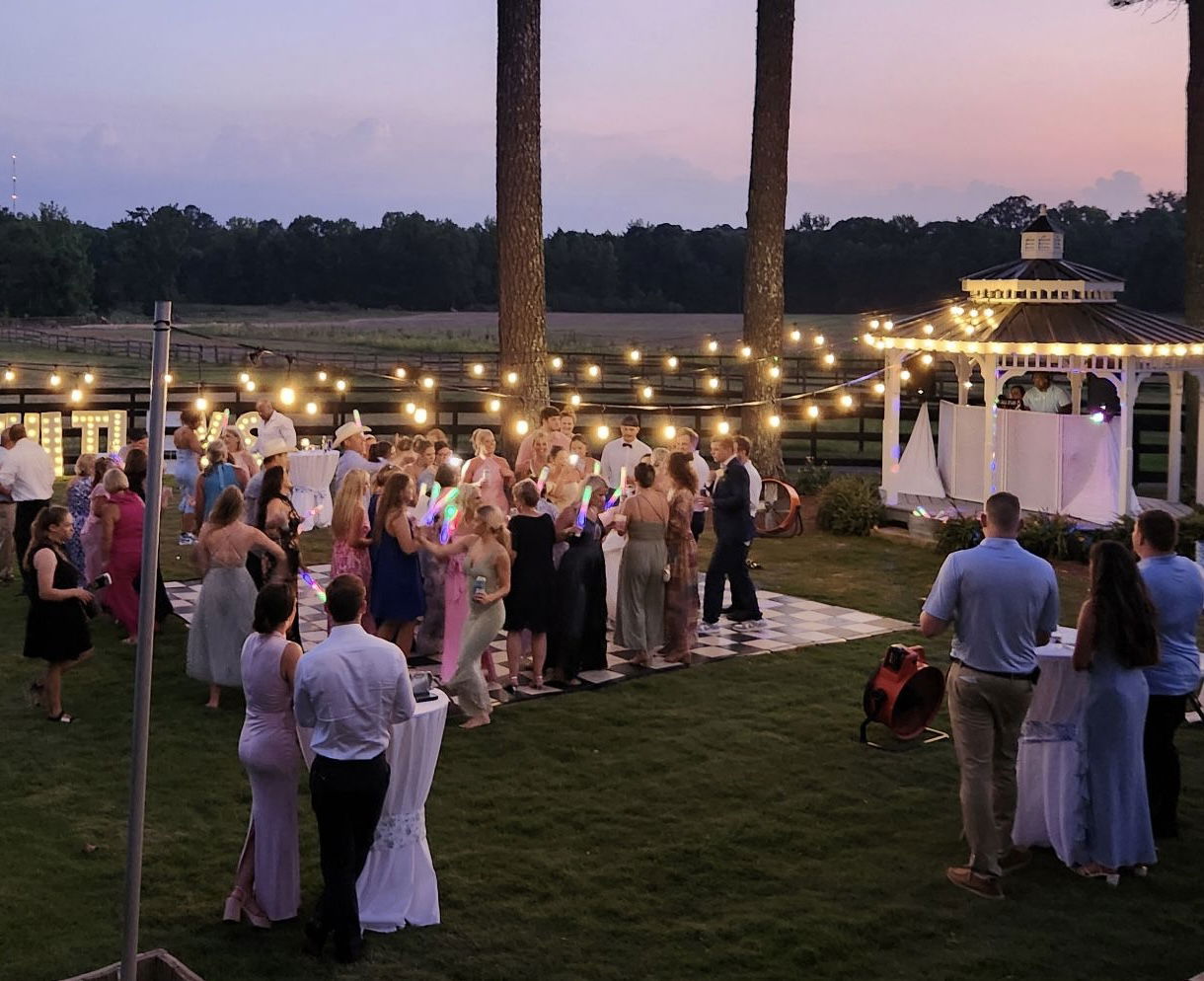 Edison bulb lighting over outdoor dance floor near gazebo with countryside setting in Monroe, GA near Athens, Georgia