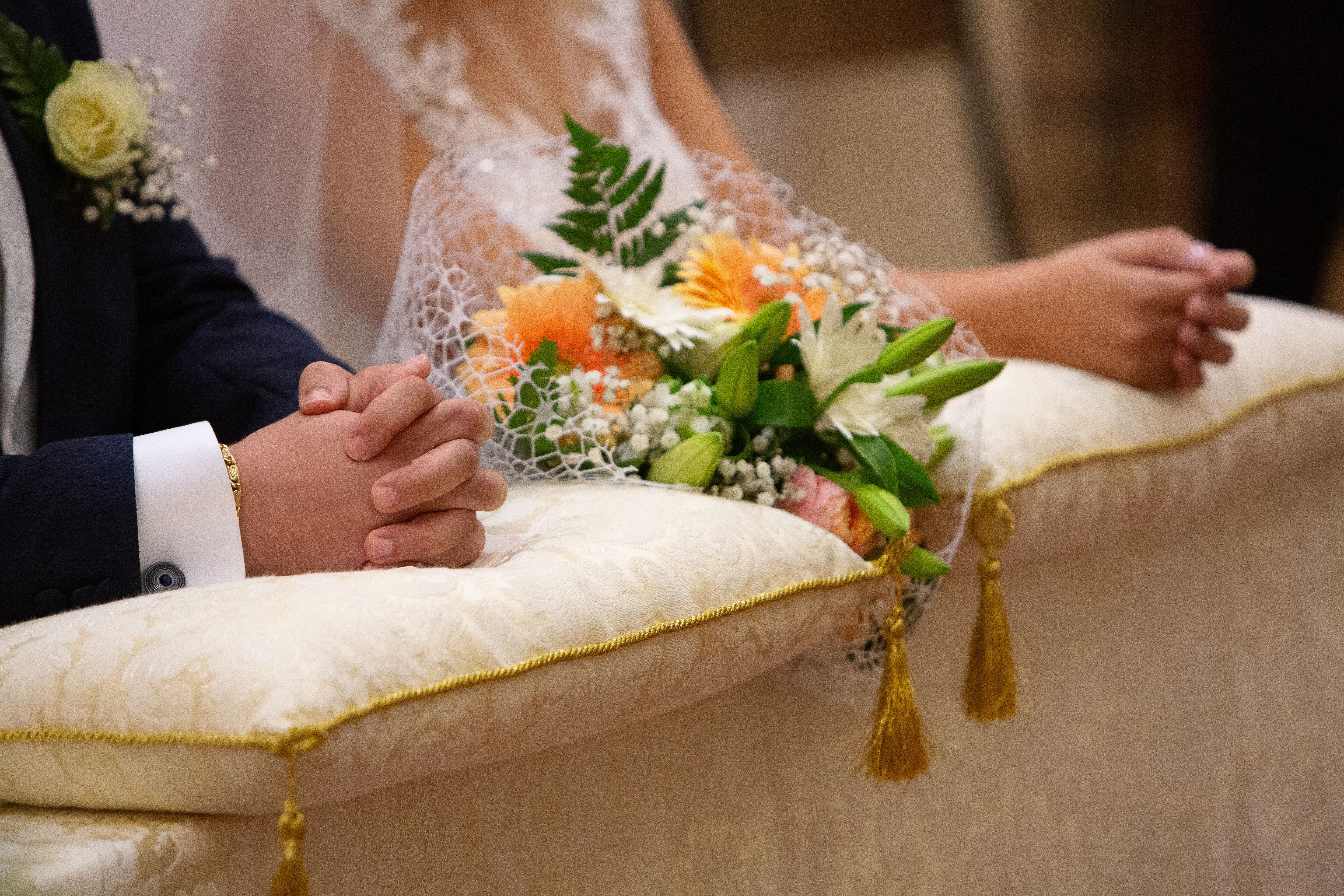 bride and groom kneeling on prayer benches at wedding venue near Winder, GA in Barrow County, Georgia 