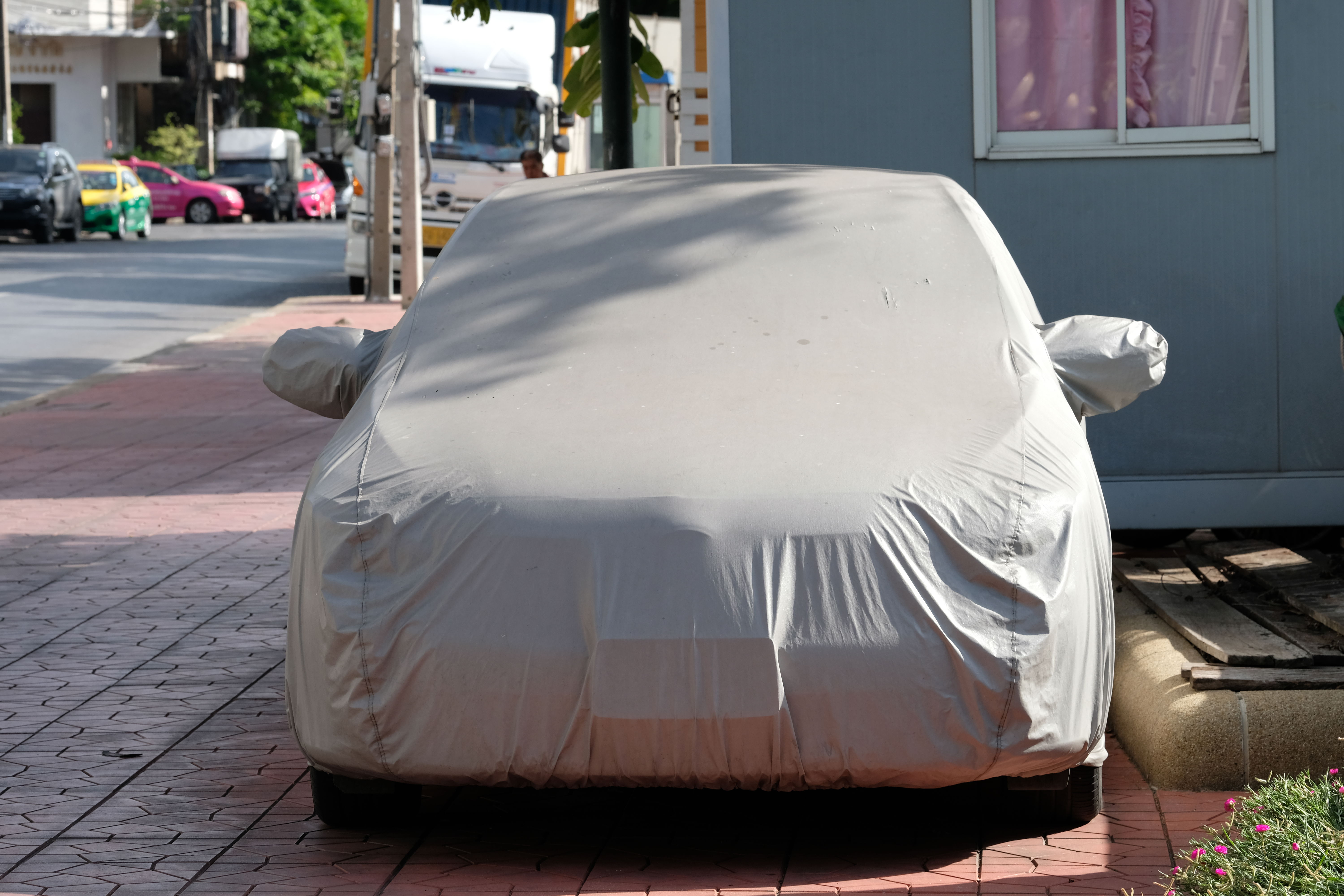 Holiday gift for car enthusiasts: windshield sunshade or car cover.