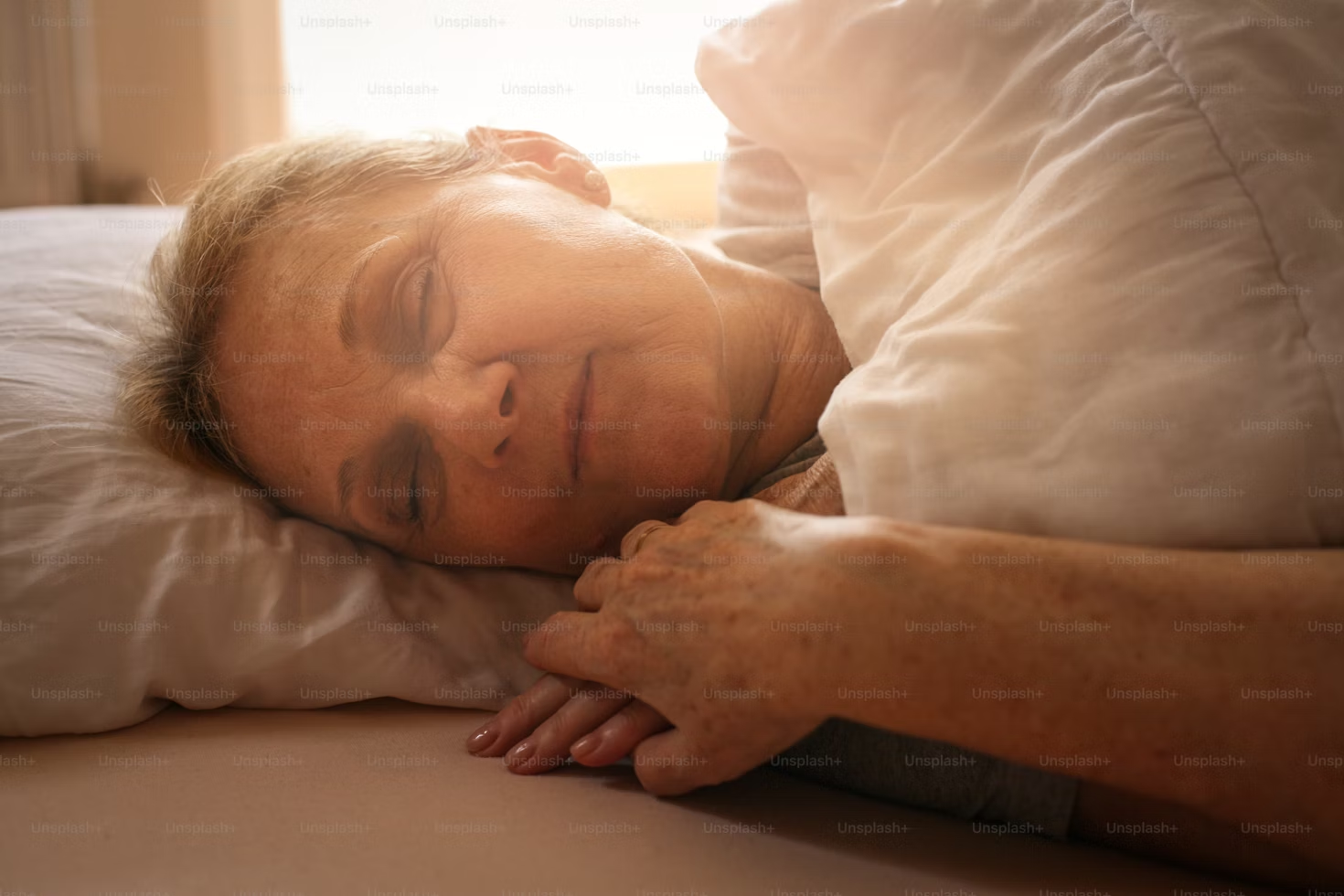 senior woman sleeping in bed alone