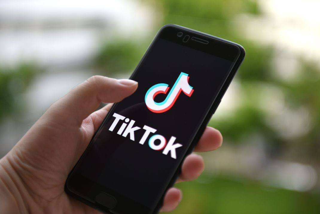 holding phone with tiktok - posting challenges content idea