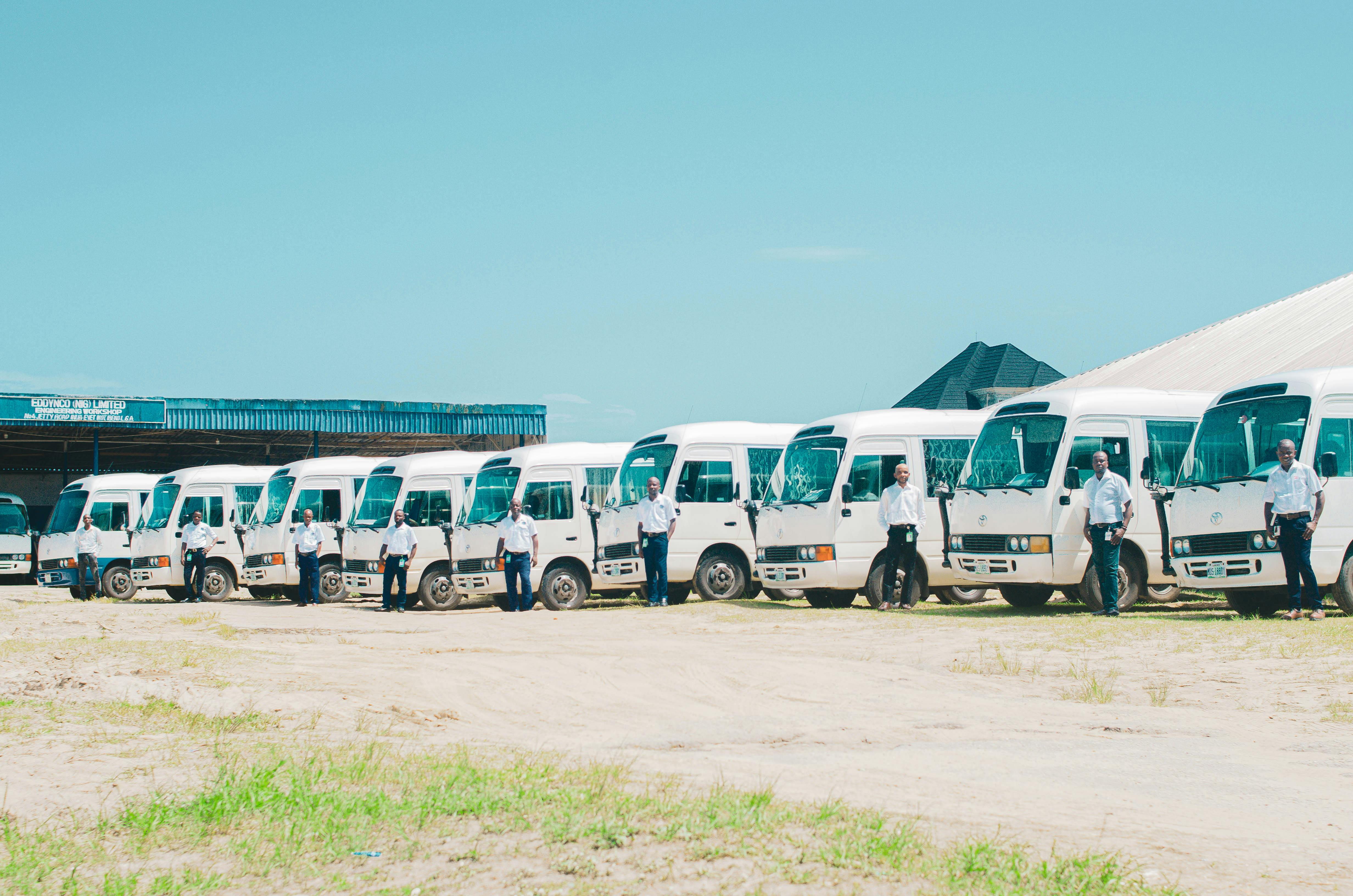 drivers standing by buses at station