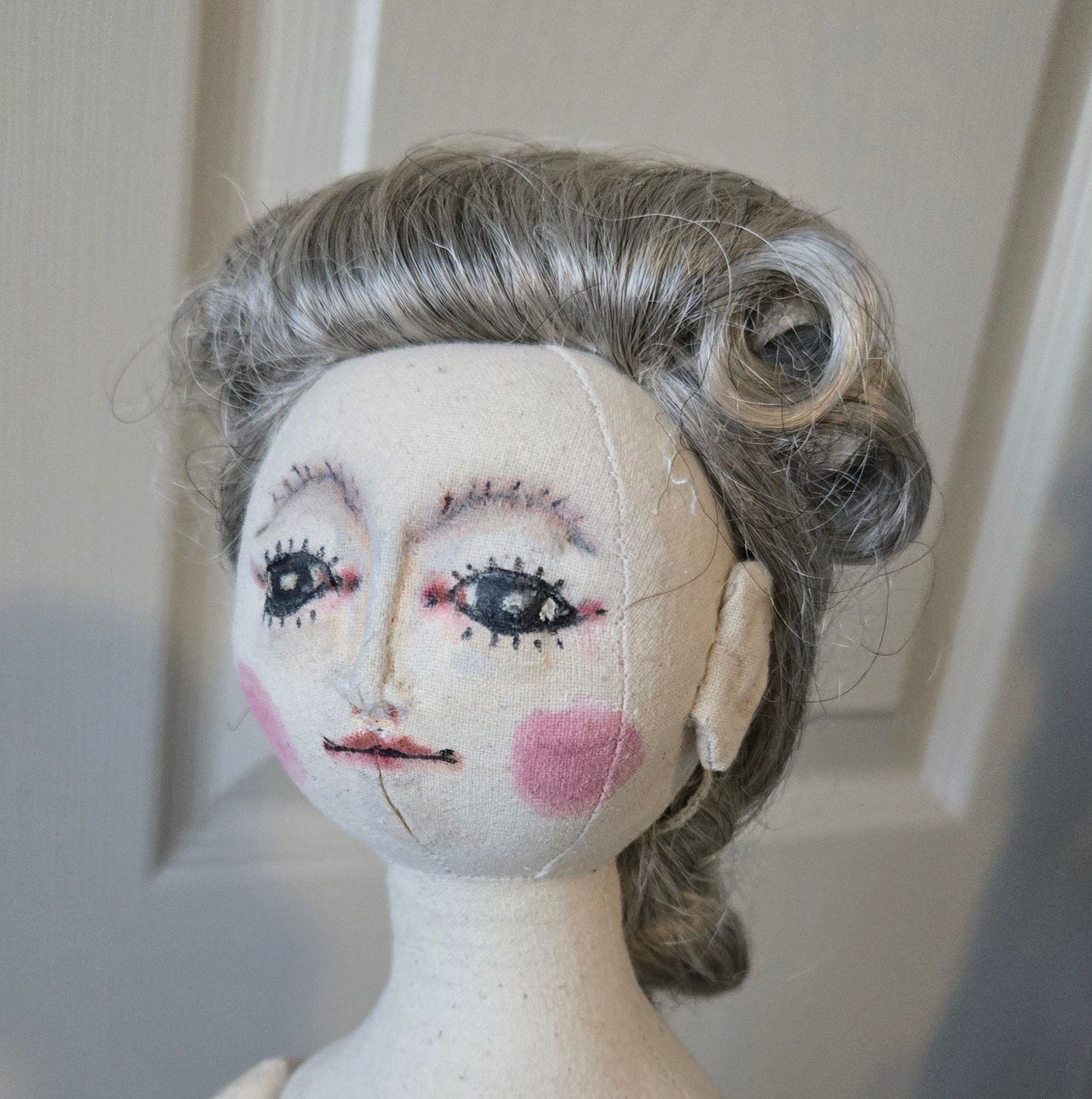 Armand tries on a new wig.