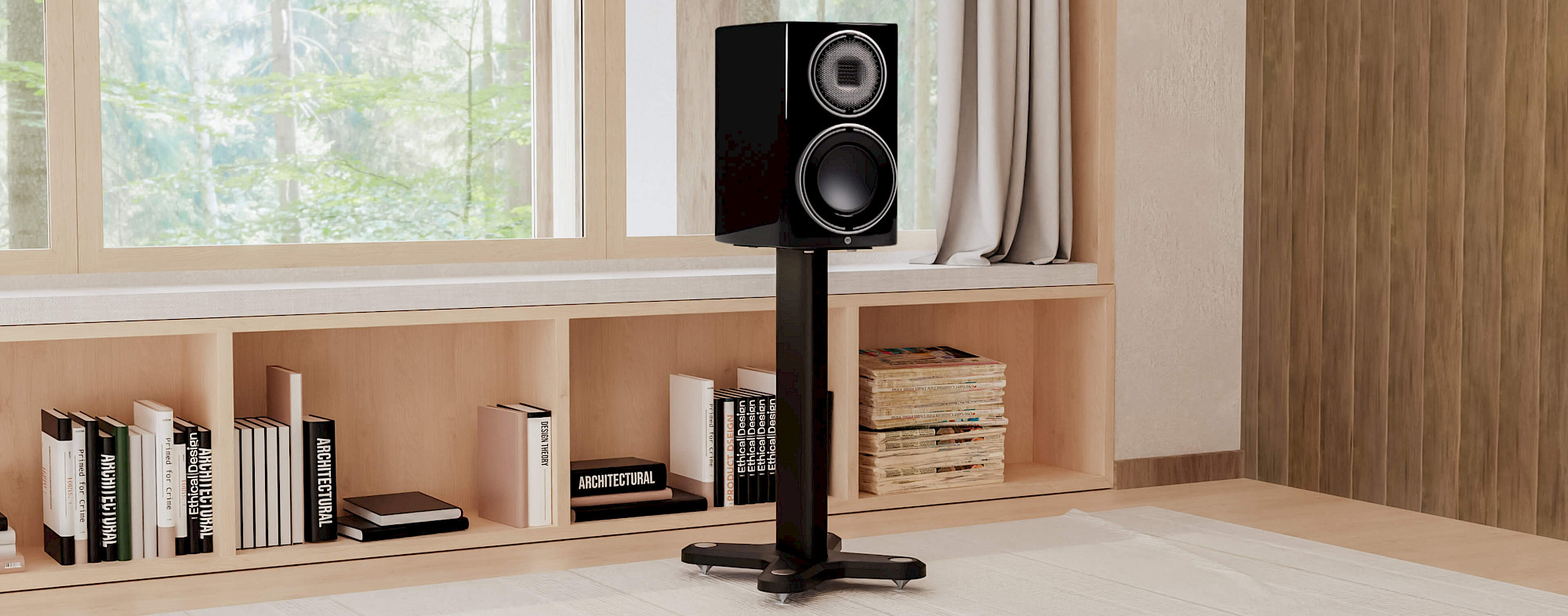 רמקול מדפי מוניטור אודיו גולד monitor audio gold שחור מונח על סטנד רצפתי st2 universal בצבע שחור בסלון מודרני על רקע ספריית עץ מלאה בספרים