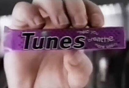 Tunes Blackcurrant Packet in someone's hand (with purple wrapper)