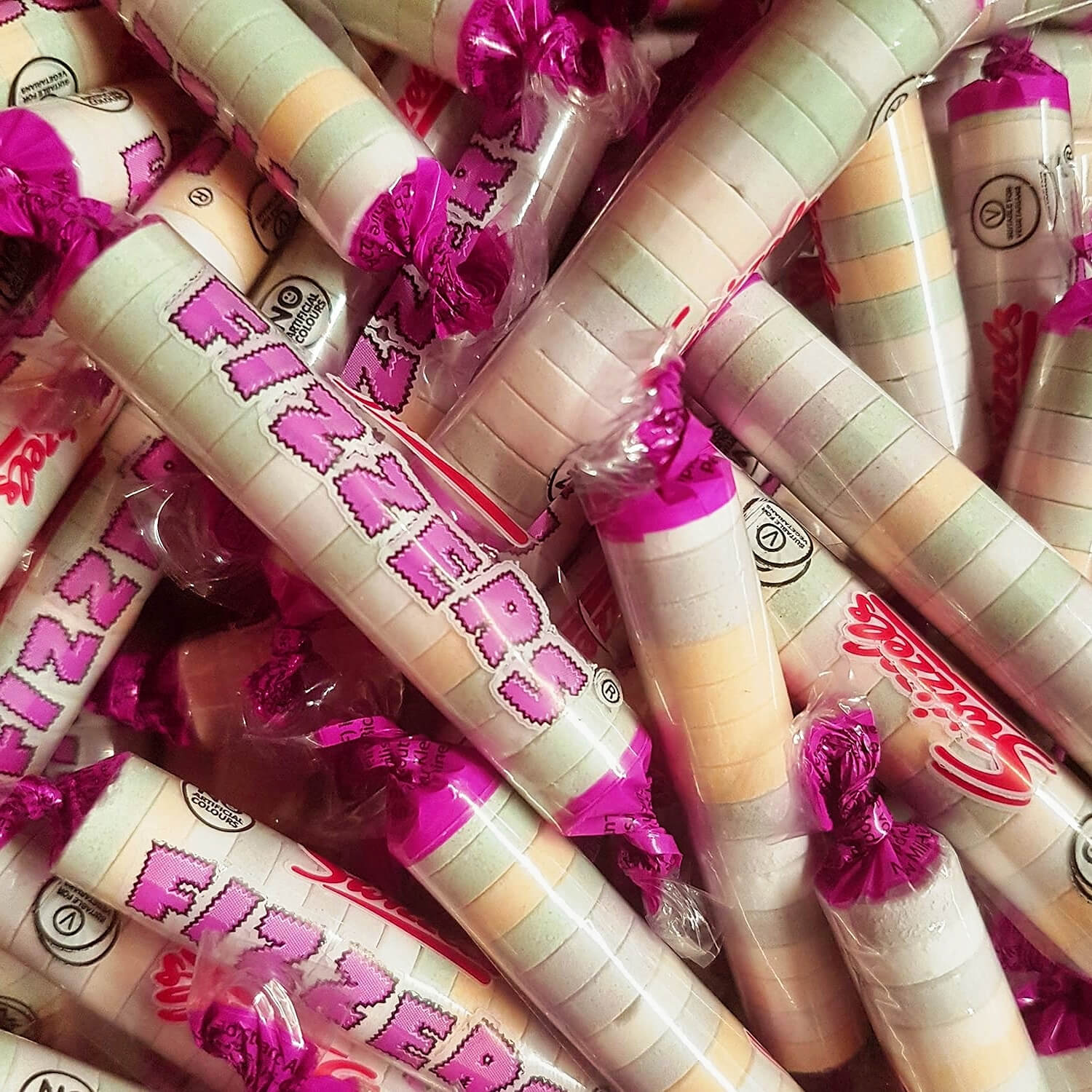 Multiple rolls of Swizzels Fizzers in a pile