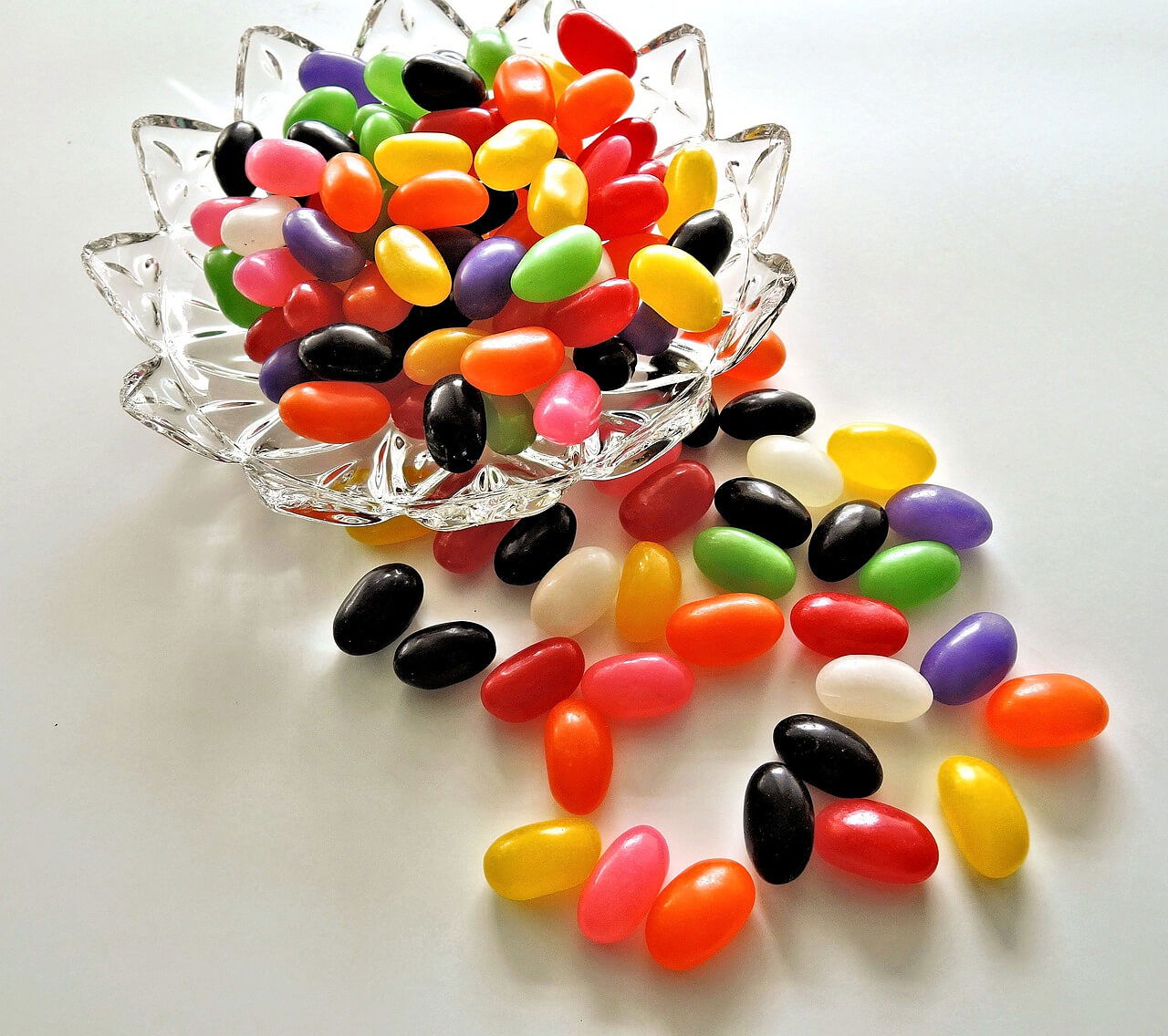 A glass dish overflowing with multi-coloured Jelly Beans