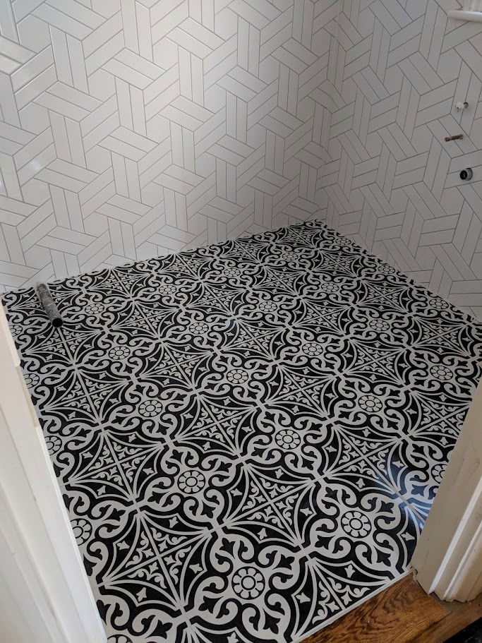 Beautiful mix of chevron wall tiles to form a wall pattern and geometric floor tiling in Wanstead