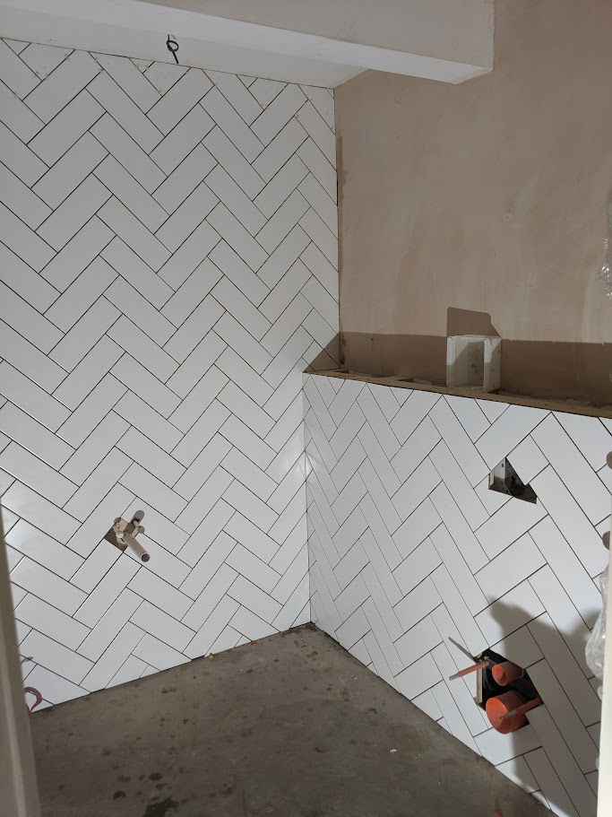 Herringbone bathroom tiling by Hunter Tiling Ltd in Witham