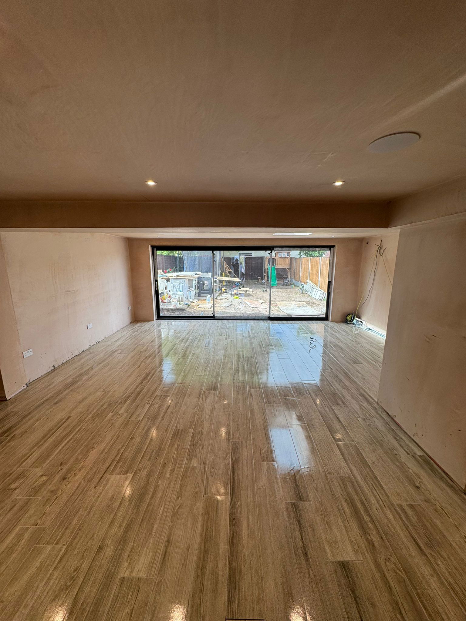 Gleaming wood plank tile in Waltham Abbey extension floor tiling
