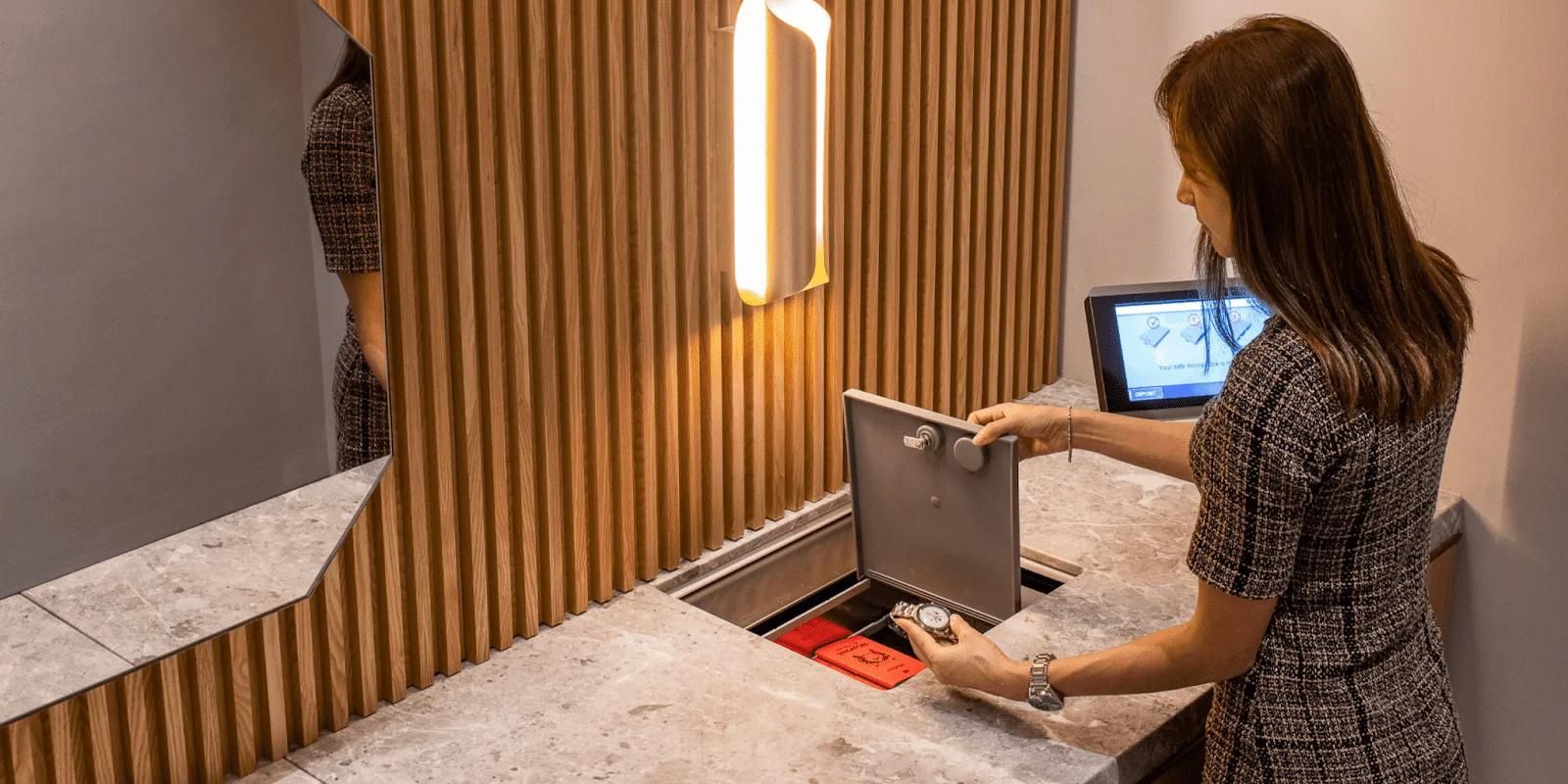 Woman Storing Valuables in STARVAULT Automated Safe Deposit Box