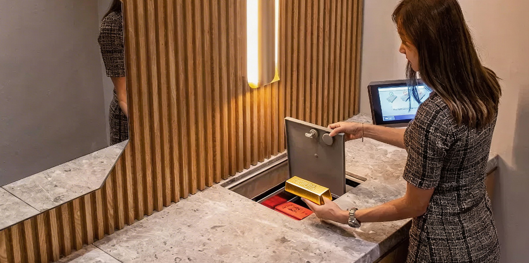 Investor placing gold bullion into a STARVAULT safe deposit box in Singapore