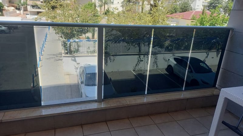 פתרון פרטיות בנהריה: ציפוי למעקה זכוכית במרפסת