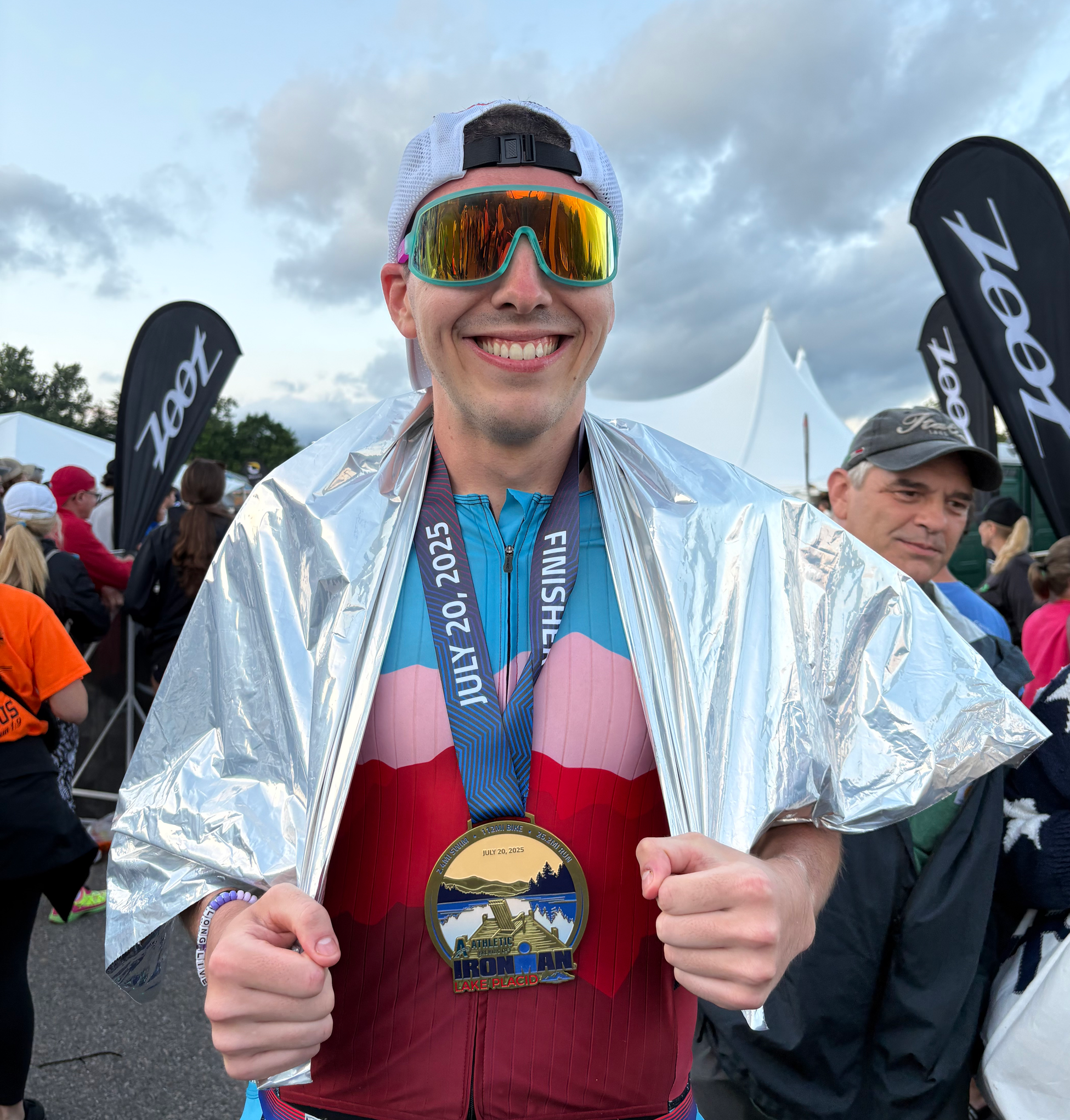 Jacob smiles with a medal around his neck after completing the IRONMAN triathlon.