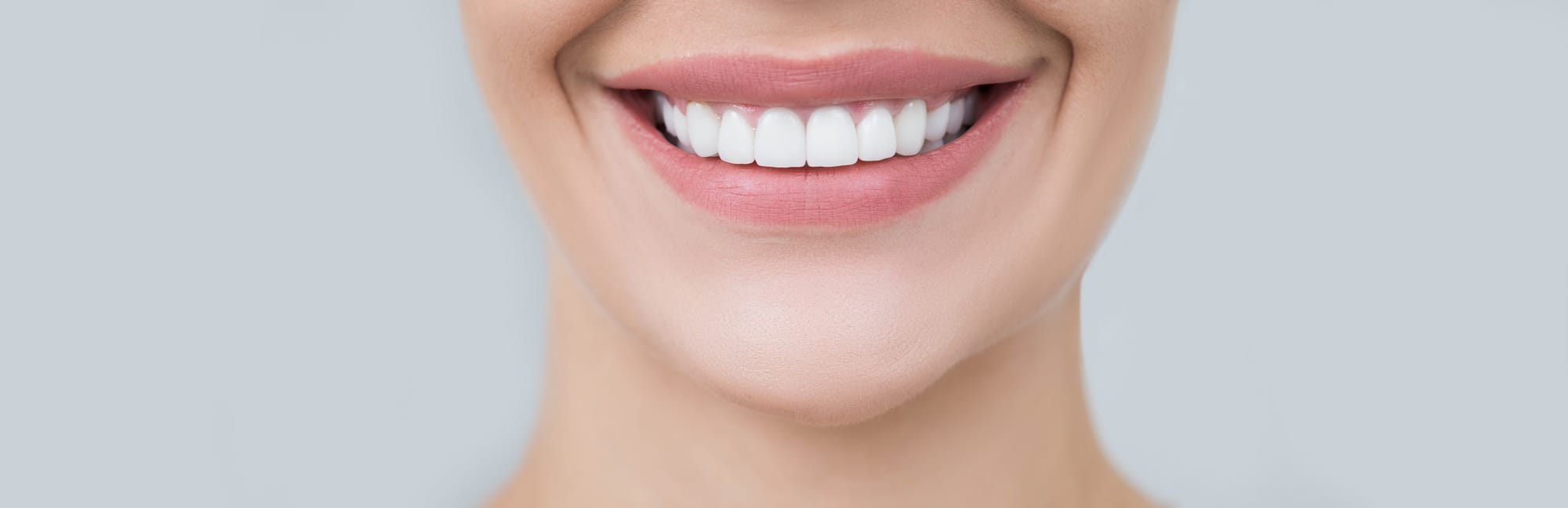 A woman smiling after her smile was restored