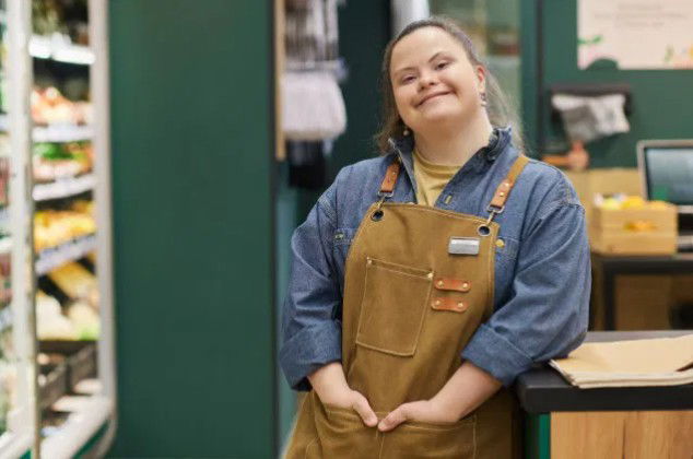 Vulnerable adult worker proudly standing in a shop