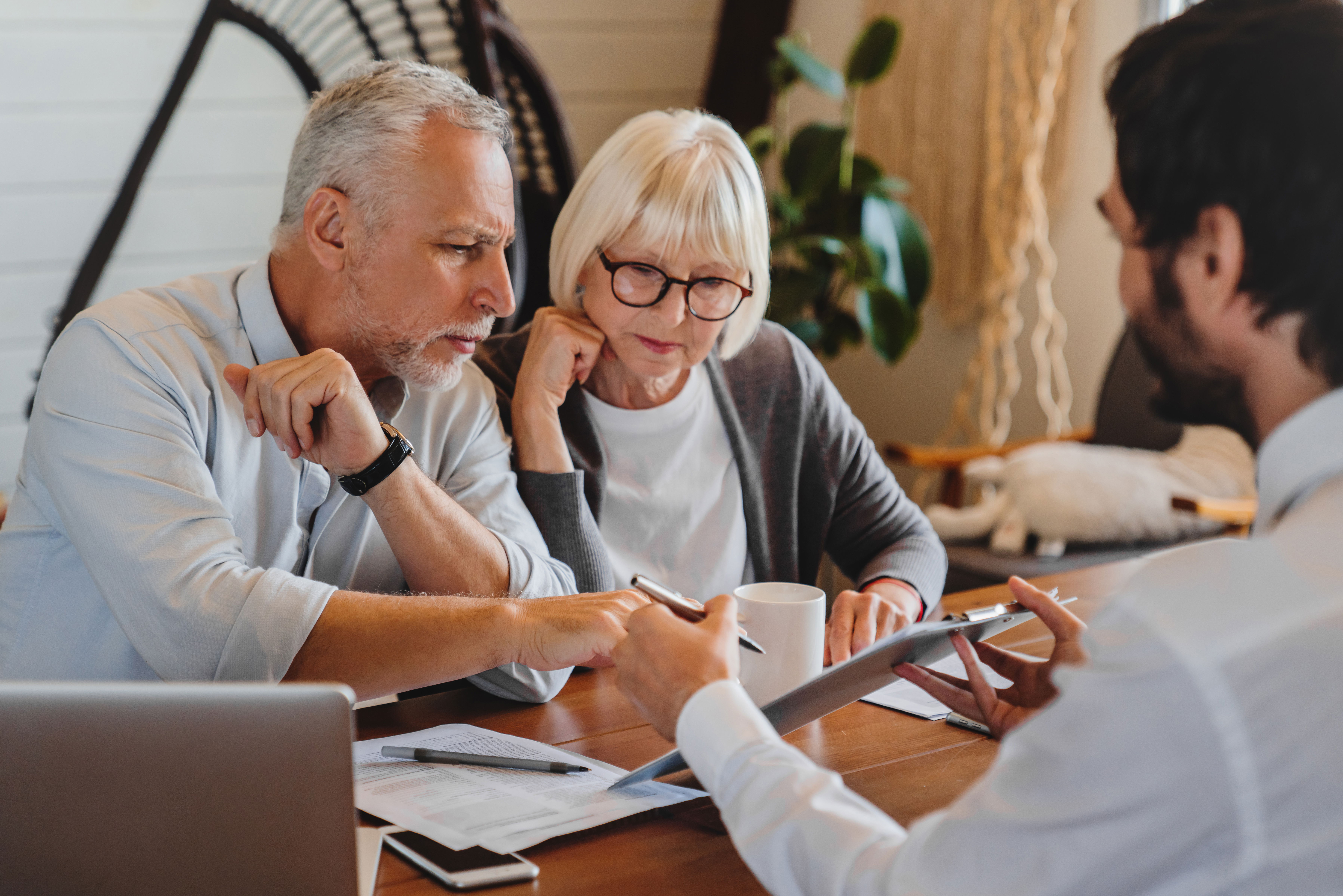 Clients discussing Premium Plus Will upgrade and trust options with advisor.