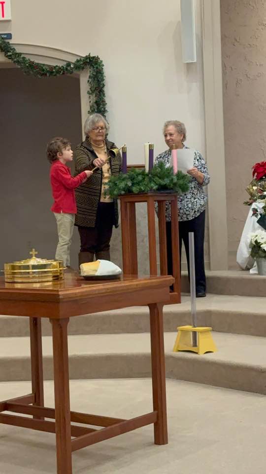 Hudson, Becky and Karen light the Advent Candle on the 1st Sunday of Advent 2024