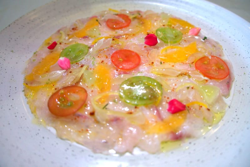 seabass carpaccio, citrus condiments, zest confit, tomatoes multicolor