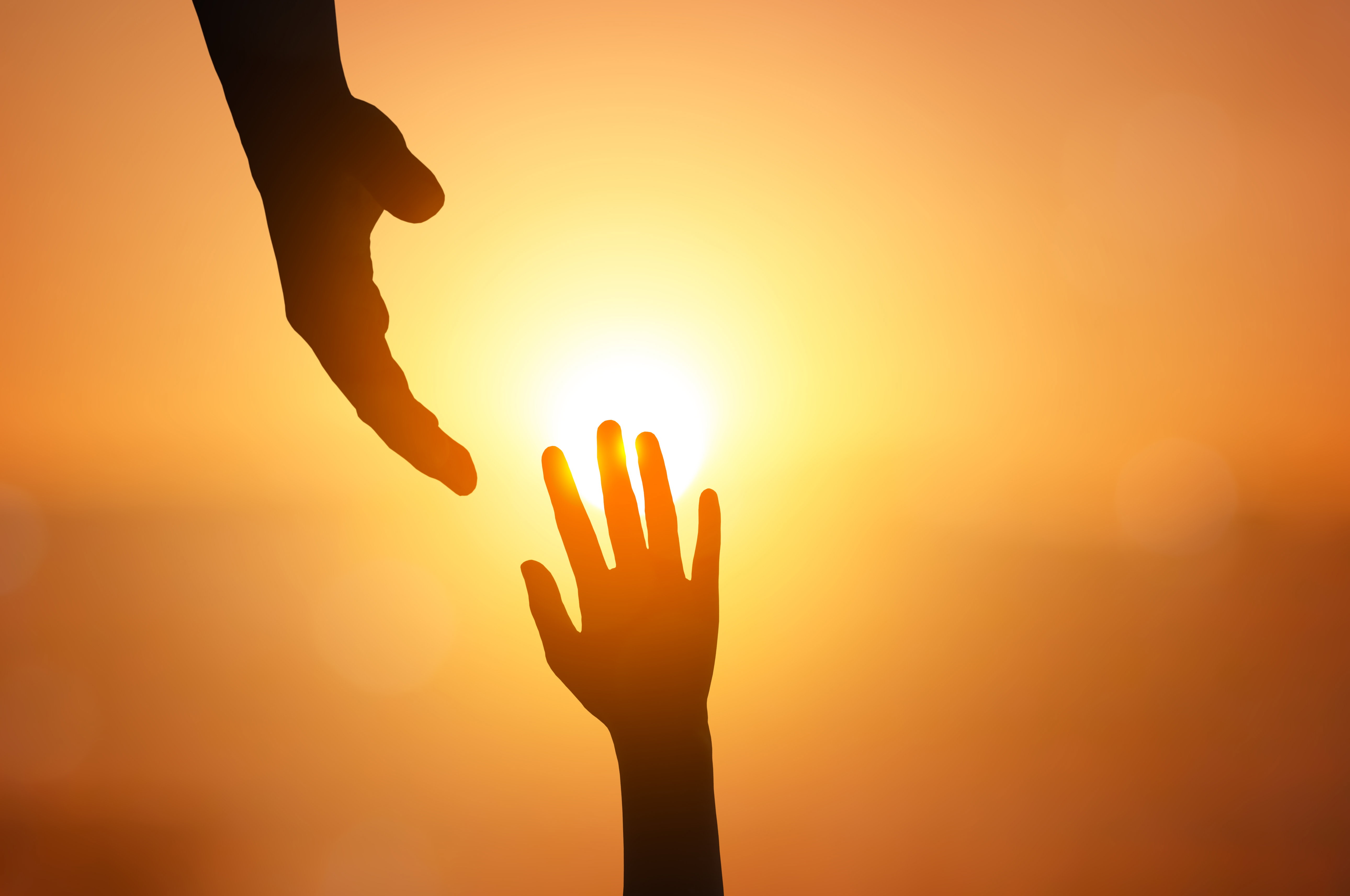 Hands reaching towards each other illustrating building trust for trauma healing