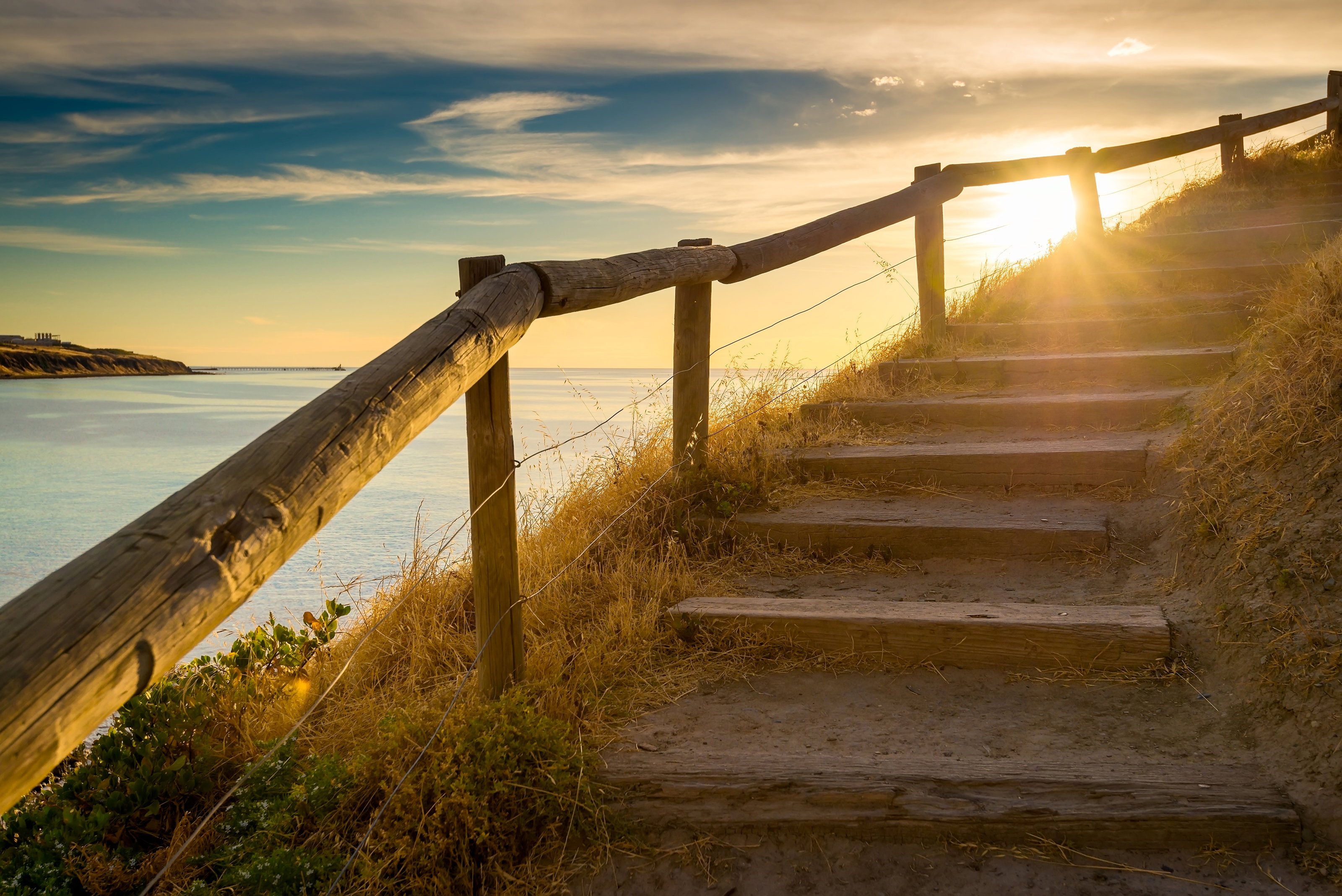 Steps near water and sunset representing healing from emetophobia through ERP therapy