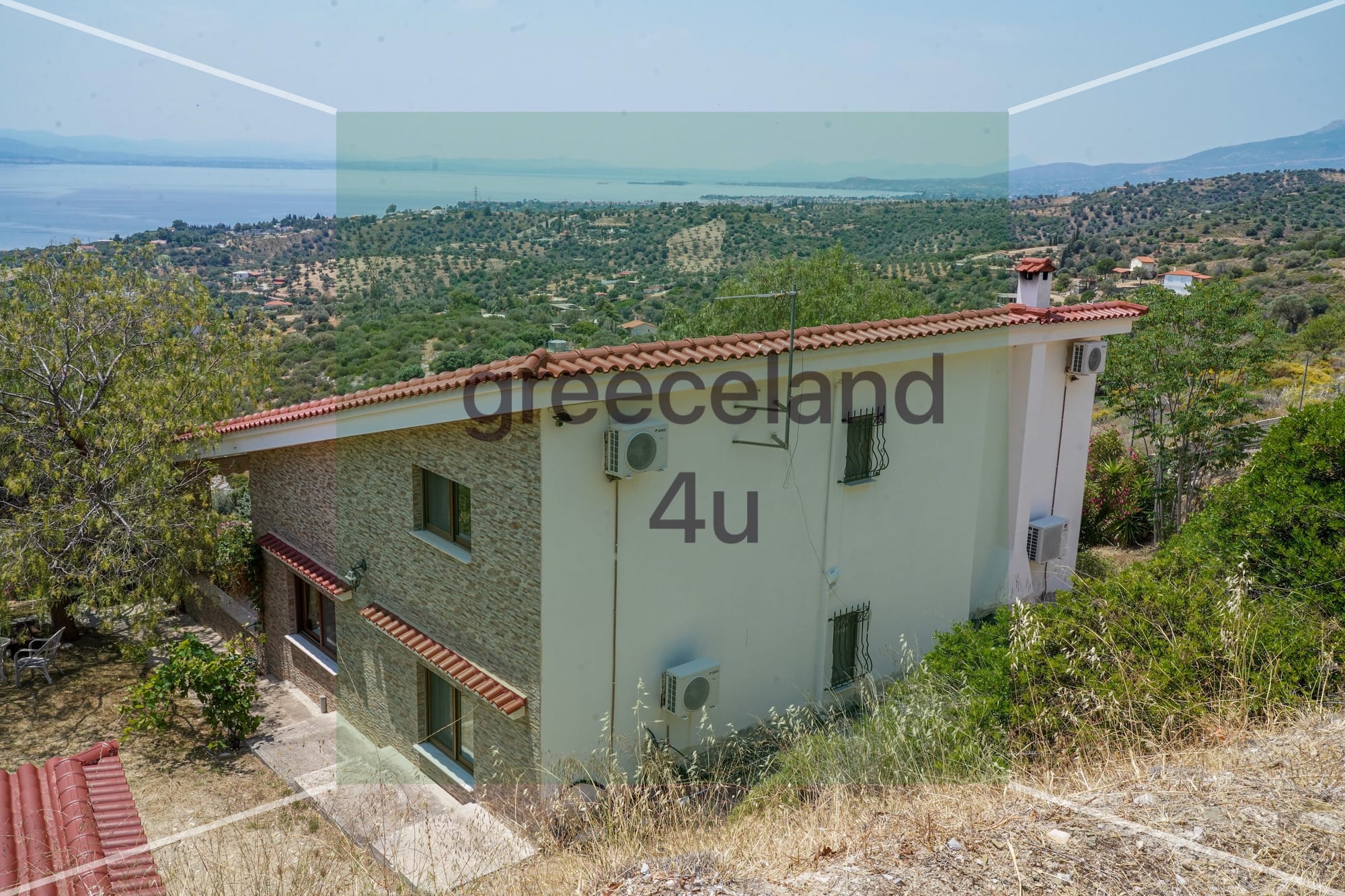 Located on a private 4,000 m² plot with stunning panoramic sea views over the Euboean Gulf.