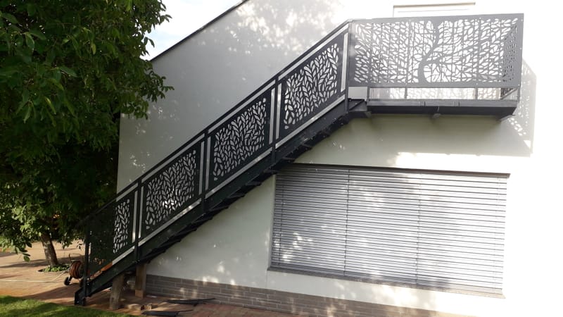 Fém lépcső, lézervágott korláttal, életfa motívummal.