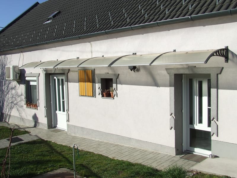 Előregyártott előtető felszerelése kőfalra.