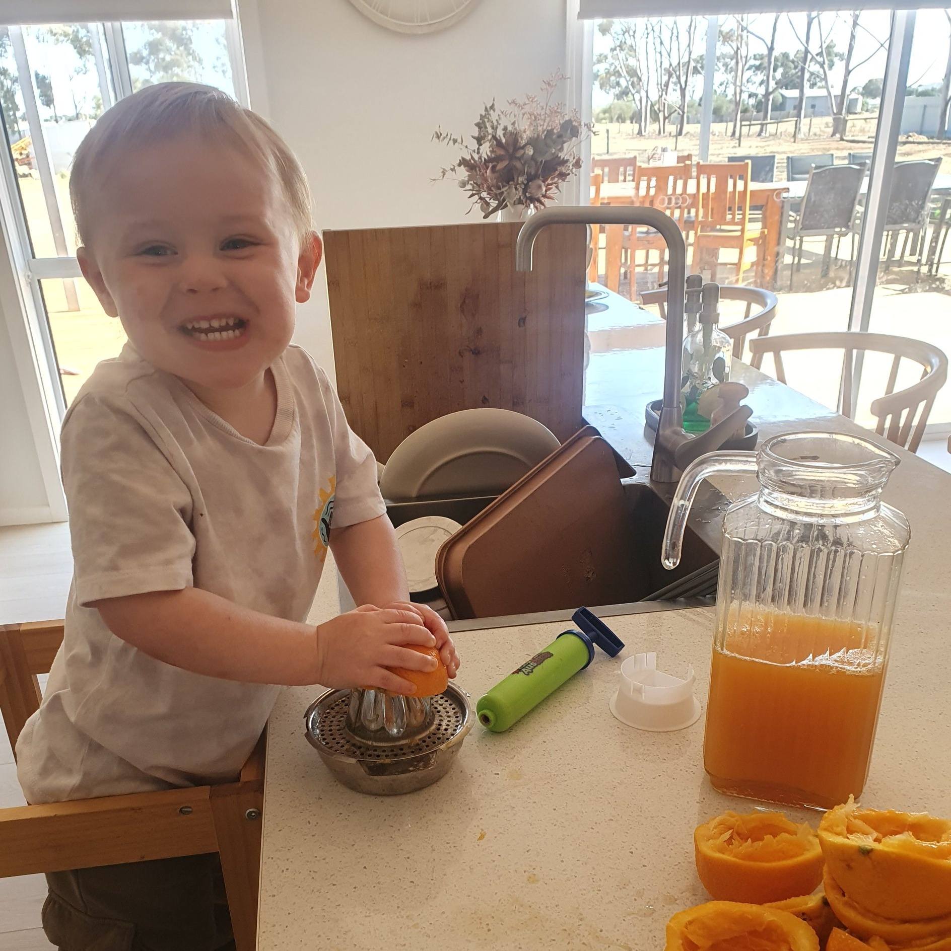 Riley having a go at juicing oranges for our homemade orange juice
