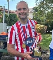 A person holding a trophyAI-generated content may be incorrect.