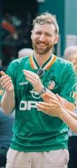 A person in a green shirtAI-generated content may be incorrect.