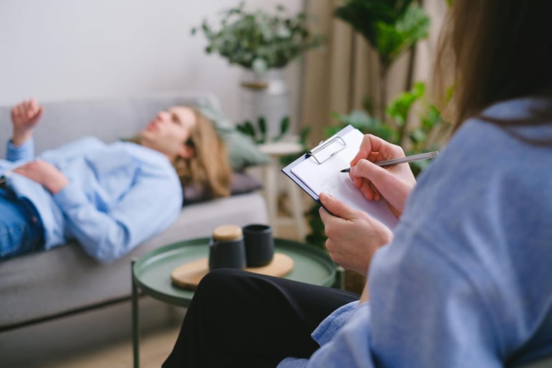 Therapist noting during a session, symbolizing Free Online Counseling