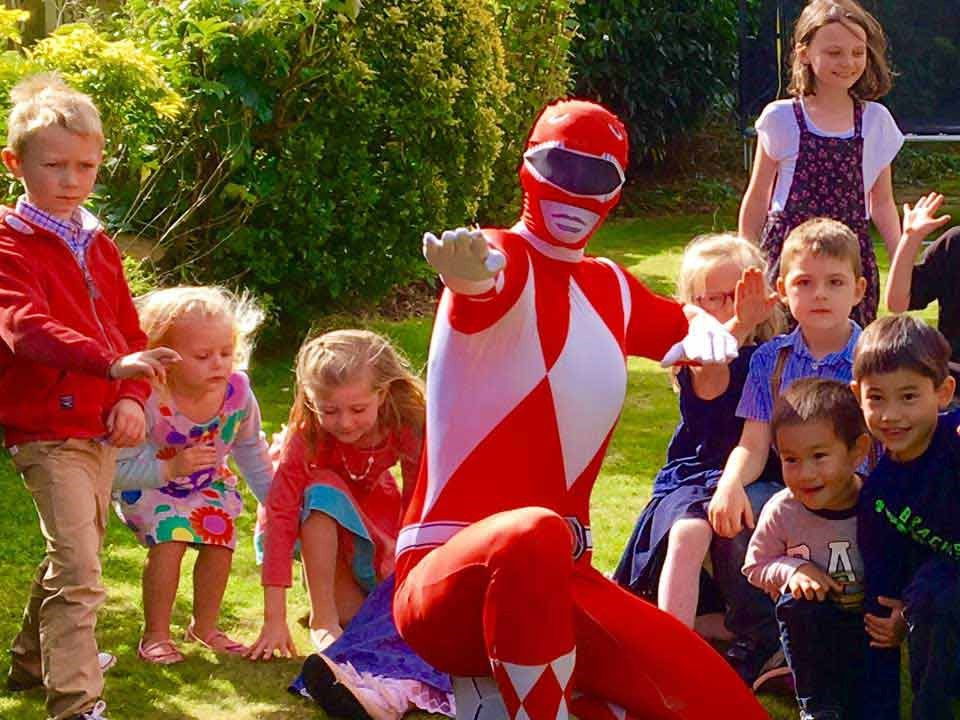 Red Power Ranger entertaining children at a kids birthday party in Toronto during a superhero party event.