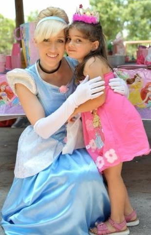 Cinderella princess entertainer hugging a child at a birthday party in Toronto.