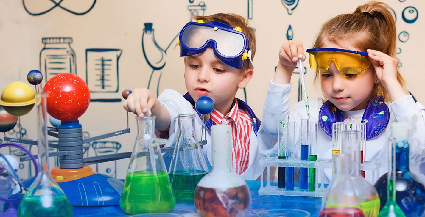 Young children wearing goggles and doing simple science experiments during a daycare and preschool science show in Toronto