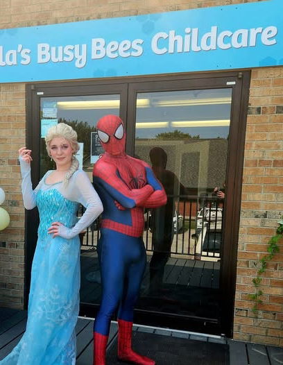 Princess character and superhero entertainer posing outside a daycare during a special kids party visit in Toronto